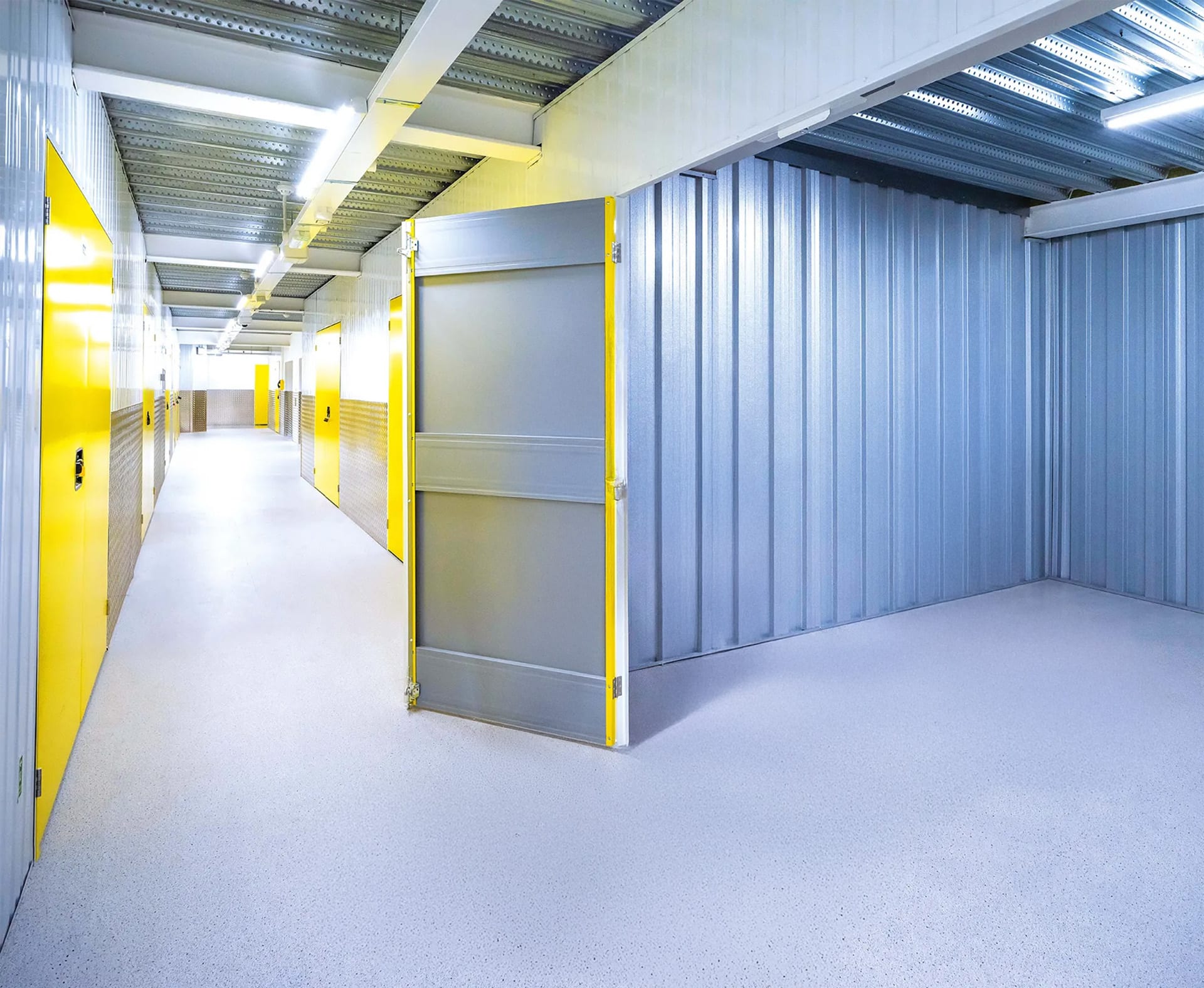 Bright corridor of yellow self-storage rooms inside a Big Yellow facility